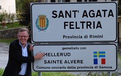 Kommunchefen Ingmar Johansson visar stolt upp infartsskylten till Sant'Agata, där kommunen anger vilka vänorter man har.